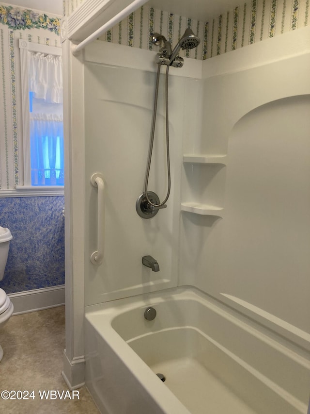 bathroom featuring toilet and shower / tub combination