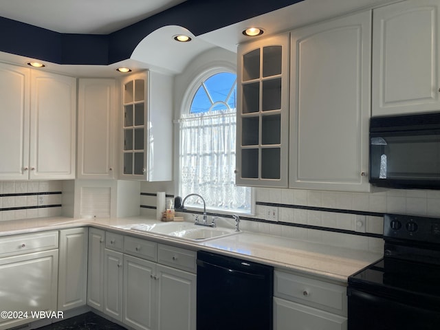 kitchen featuring white cabinets, sink, a healthy amount of sunlight, and black appliances