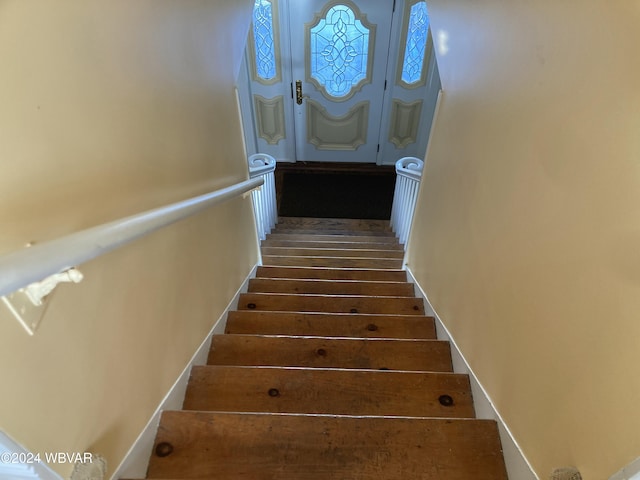 staircase featuring wood-type flooring