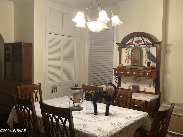 dining space with a chandelier and crown molding