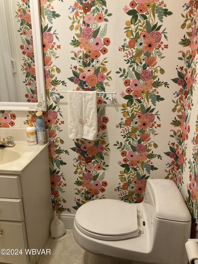 bathroom with tile patterned flooring, vanity, and toilet