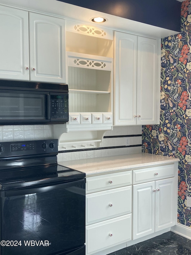 kitchen featuring white cabinetry and black appliances