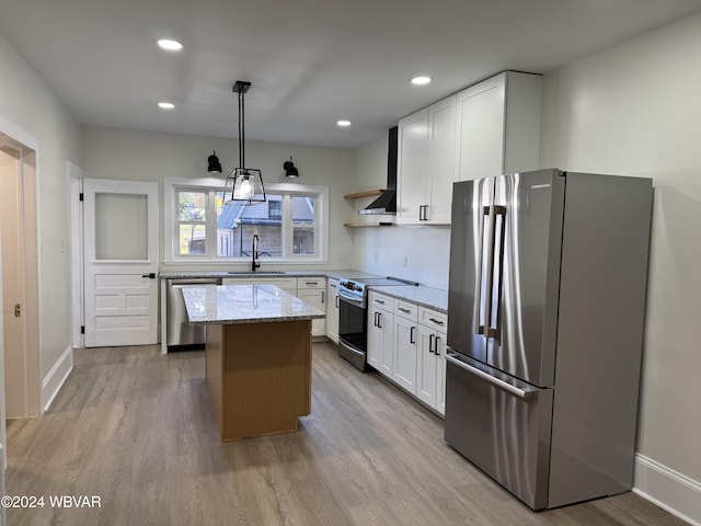 kitchen featuring a kitchen island, white cabinetry, hanging light fixtures, and appliances with stainless steel finishes