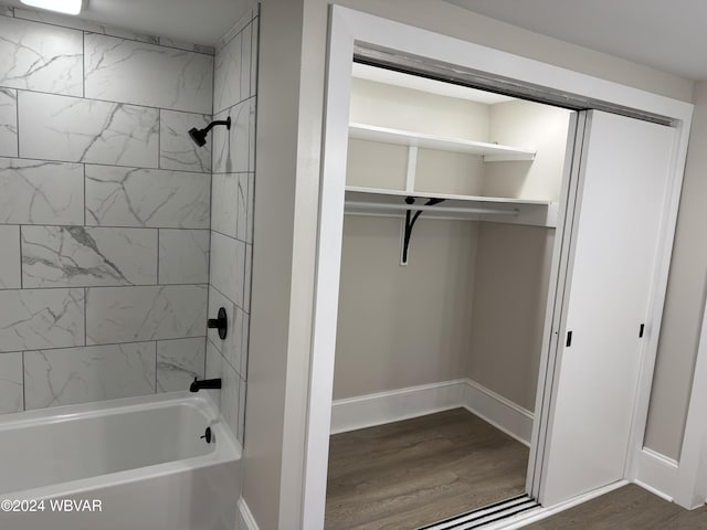 bathroom featuring hardwood / wood-style flooring and tiled shower / bath