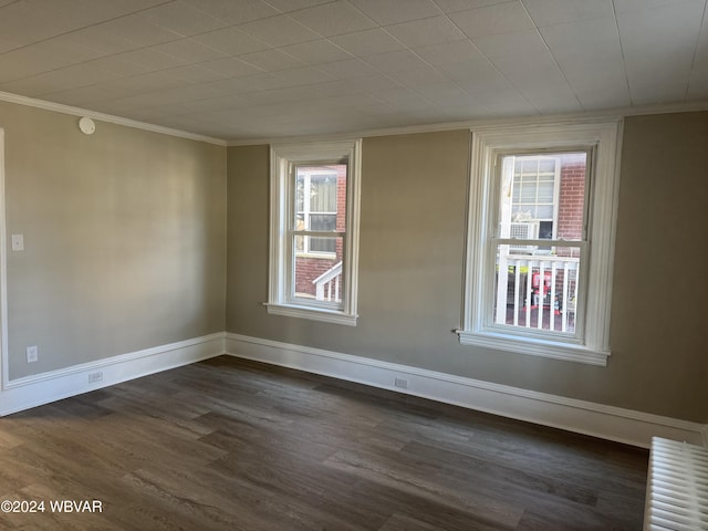 unfurnished room with dark wood-type flooring and ornamental molding