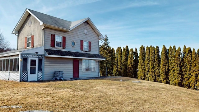 exterior space with a sunroom and a front lawn