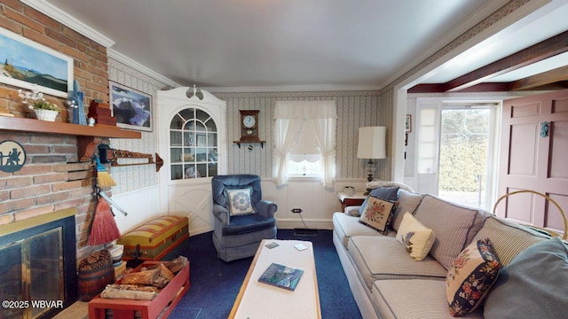 living room featuring ornamental molding, a brick fireplace, and wallpapered walls