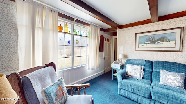 living area featuring wallpapered walls, carpet, baseboards, and beamed ceiling