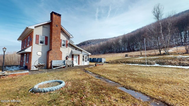 view of home's exterior with a yard and a chimney