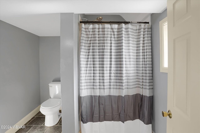 bathroom featuring tile patterned flooring and toilet