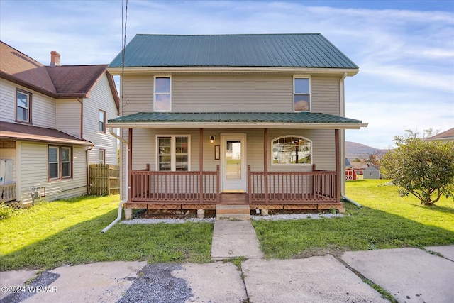 view of front of property with covered porch and a front lawn