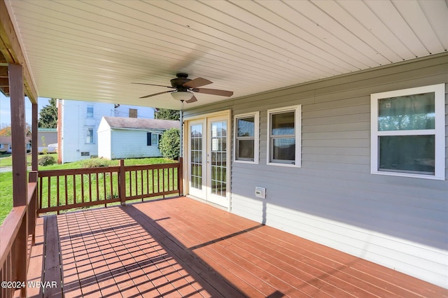 deck with french doors, ceiling fan, and a lawn