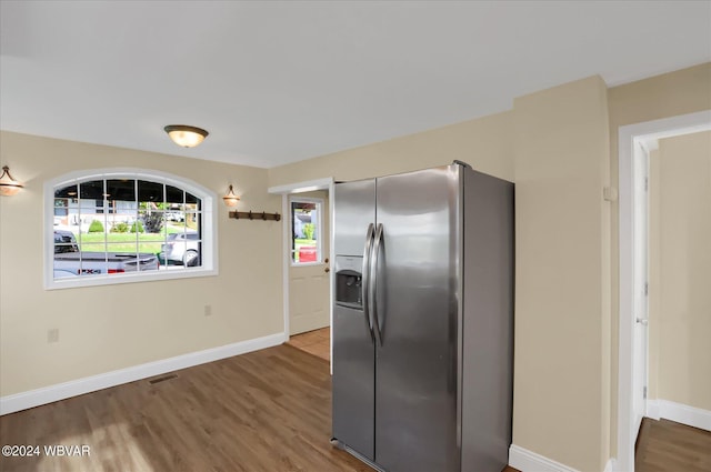 kitchen featuring stainless steel fridge with ice dispenser and hardwood / wood-style floors