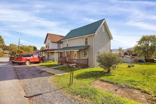 view of front of house with covered porch and a front yard