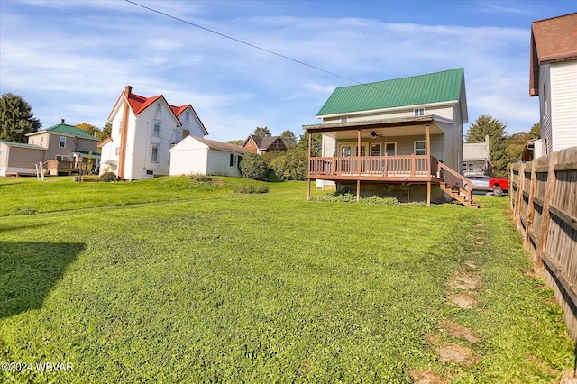 view of yard with ceiling fan and a porch