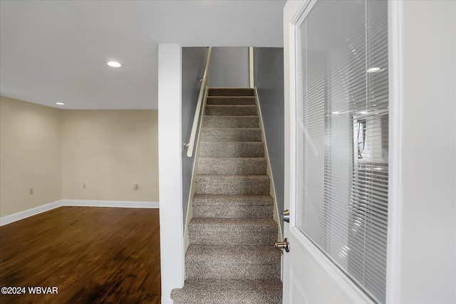 staircase featuring wood-type flooring