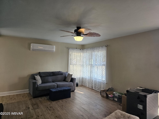 living room featuring baseboards, a wall mounted AC, ceiling fan, and wood finished floors