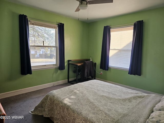 bedroom with baseboards, multiple windows, ceiling fan, and carpet flooring