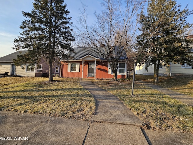 bungalow featuring a front yard and board and batten siding