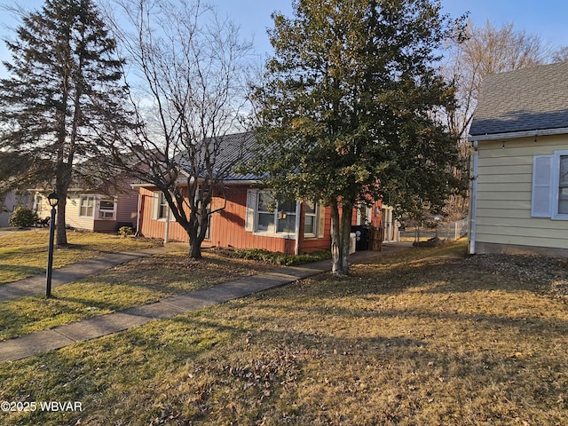 view of side of home featuring a lawn