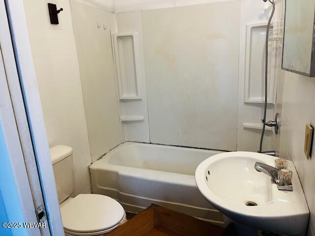 full bathroom featuring washtub / shower combination, sink, and toilet