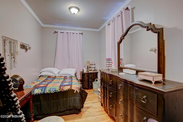 bedroom featuring light wood-type flooring and ornamental molding