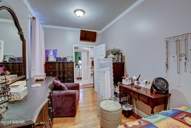 bedroom with ornamental molding and wood finished floors