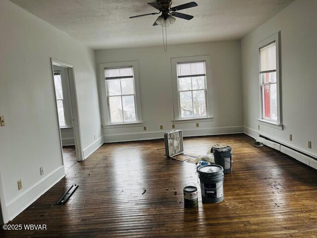 spare room featuring ceiling fan and dark hardwood / wood-style floors