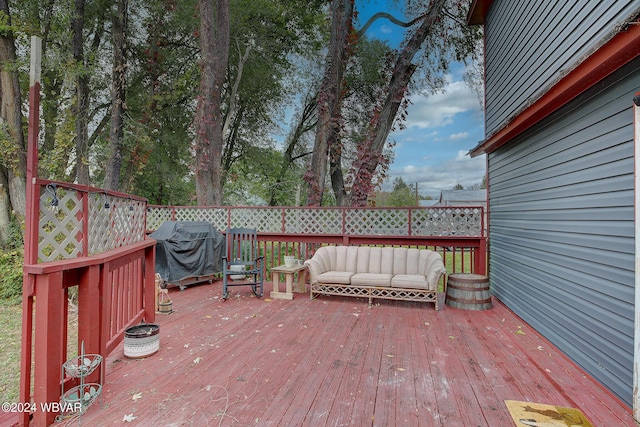 deck featuring outdoor lounge area and grilling area