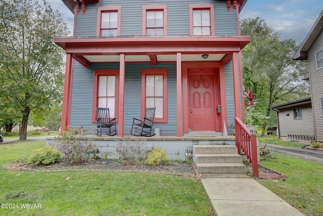 view of front of property featuring a porch and a front yard