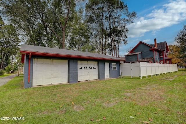 garage featuring a lawn