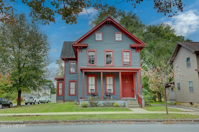 victorian home with covered porch and a front yard