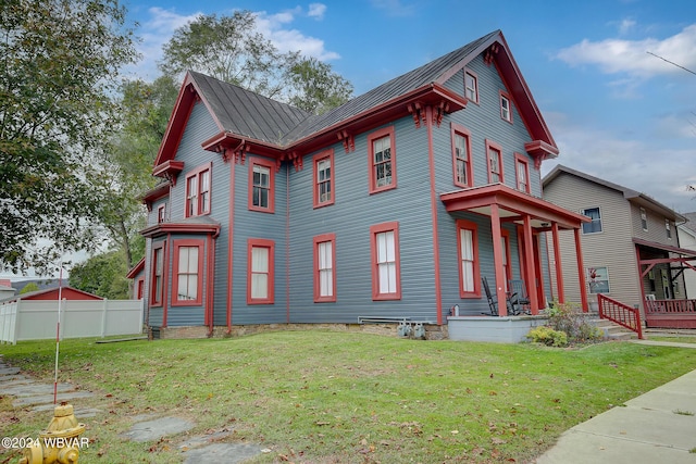 view of property exterior featuring a lawn and a porch