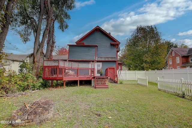 back of house featuring fence private yard, a lawn, and a wooden deck