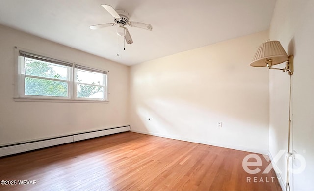 empty room featuring a baseboard radiator, wood finished floors, a ceiling fan, and baseboards