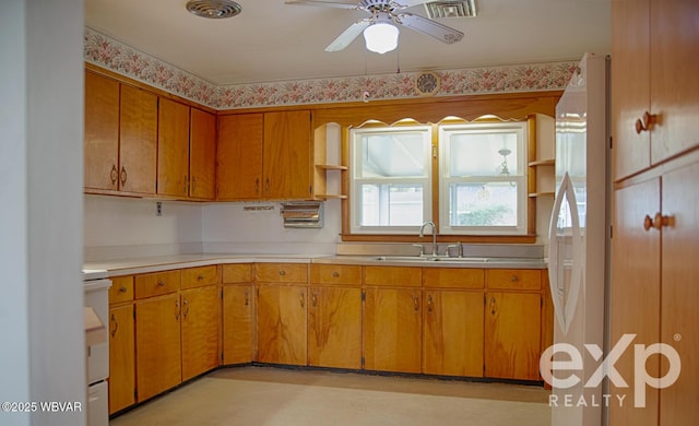 kitchen with open shelves, light countertops, visible vents, a sink, and range