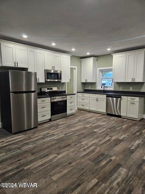131 Spring House Rd, Muncy Valley, PA 17758 - kitchen with dark countertops, dark wood-style floors, stainless steel appliances, and a sink