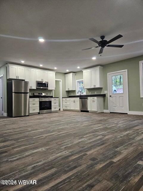 131 Spring House Rd, Muncy Valley, PA 17758 - kitchen featuring dark wood finished floors, dark countertops, a wealth of natural light, baseboards, and appliances with stainless steel finishes