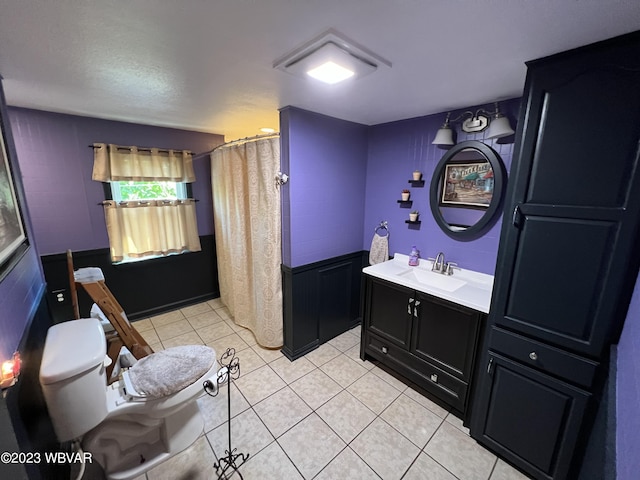 bathroom with curtained shower, tile patterned floors, a textured ceiling, toilet, and vanity