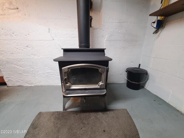 room details with a wood stove and concrete flooring