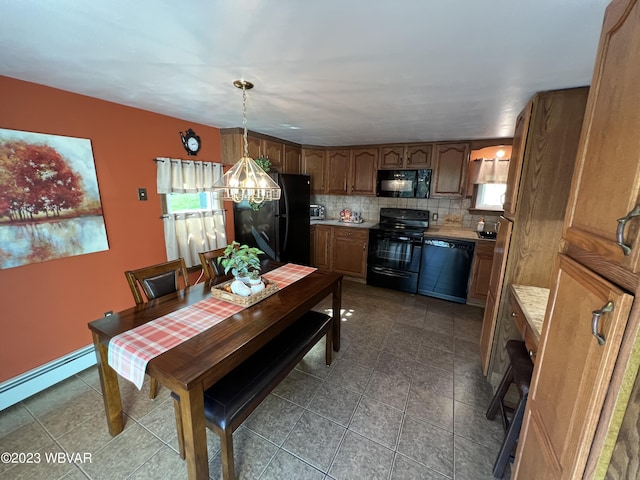 dining room with dark tile patterned floors and a baseboard radiator