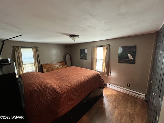 bedroom featuring dark wood-type flooring and a baseboard radiator