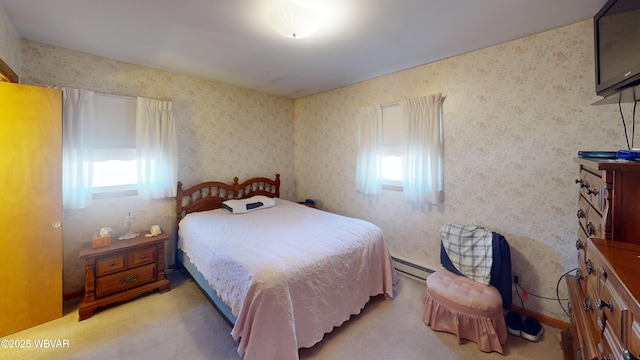 carpeted bedroom with a baseboard heating unit and wallpapered walls