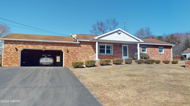 ranch-style home with brick siding, driveway, a front lawn, and a garage