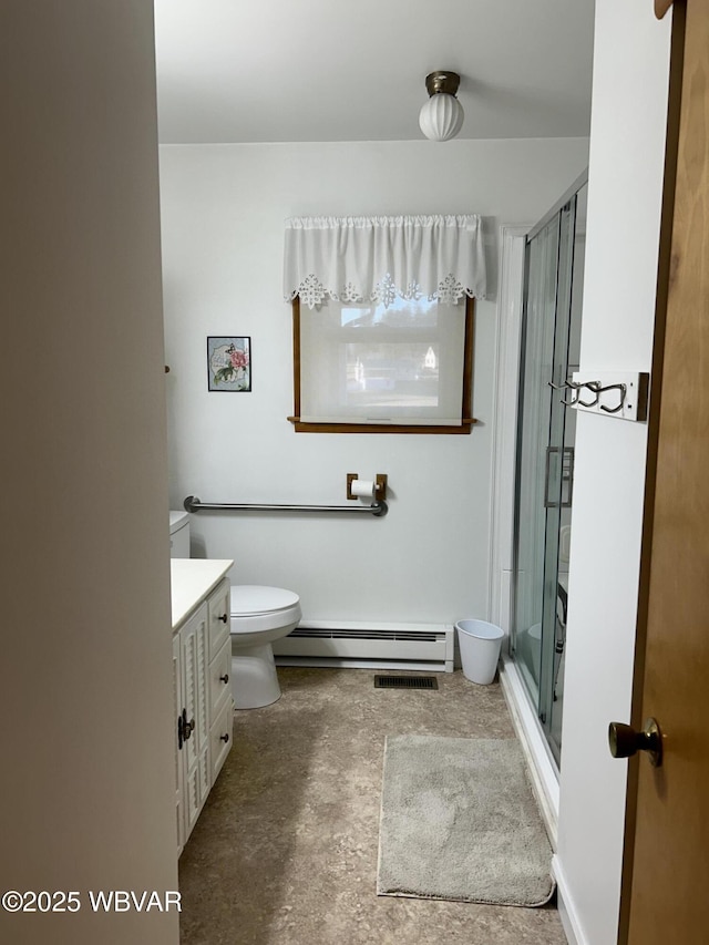 full bath with vanity, concrete floors, a baseboard radiator, a stall shower, and toilet