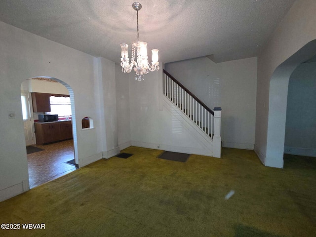 2602 W Fourth St, Williamsport, PA 17701 - unfurnished dining area featuring arched walkways, carpet flooring, a textured ceiling, a chandelier, and stairs