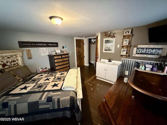 bedroom featuring concrete flooring and a sink