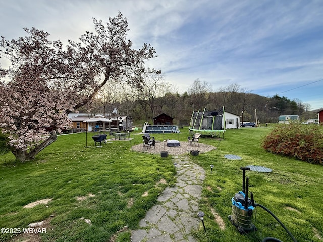 view of yard with a trampoline