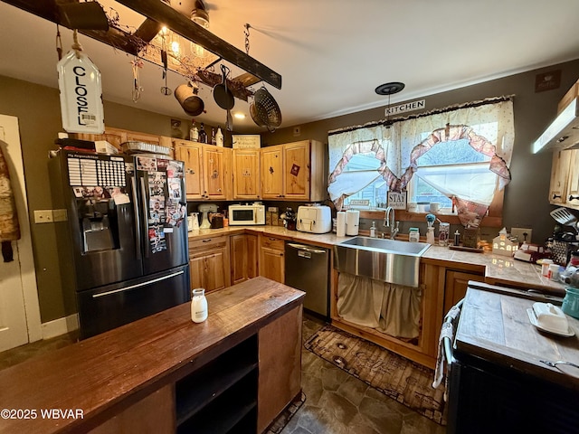 kitchen with butcher block counters, a sink, and black appliances