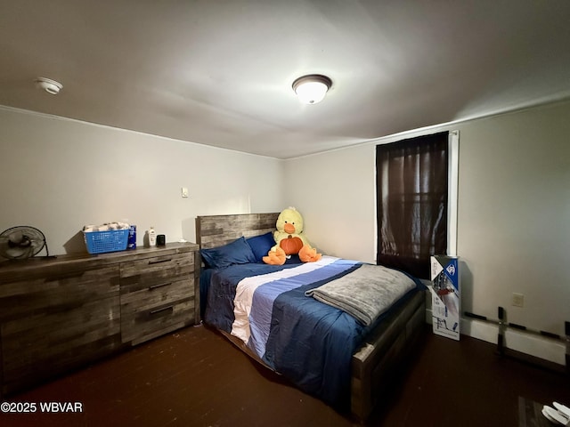 bedroom with dark wood finished floors